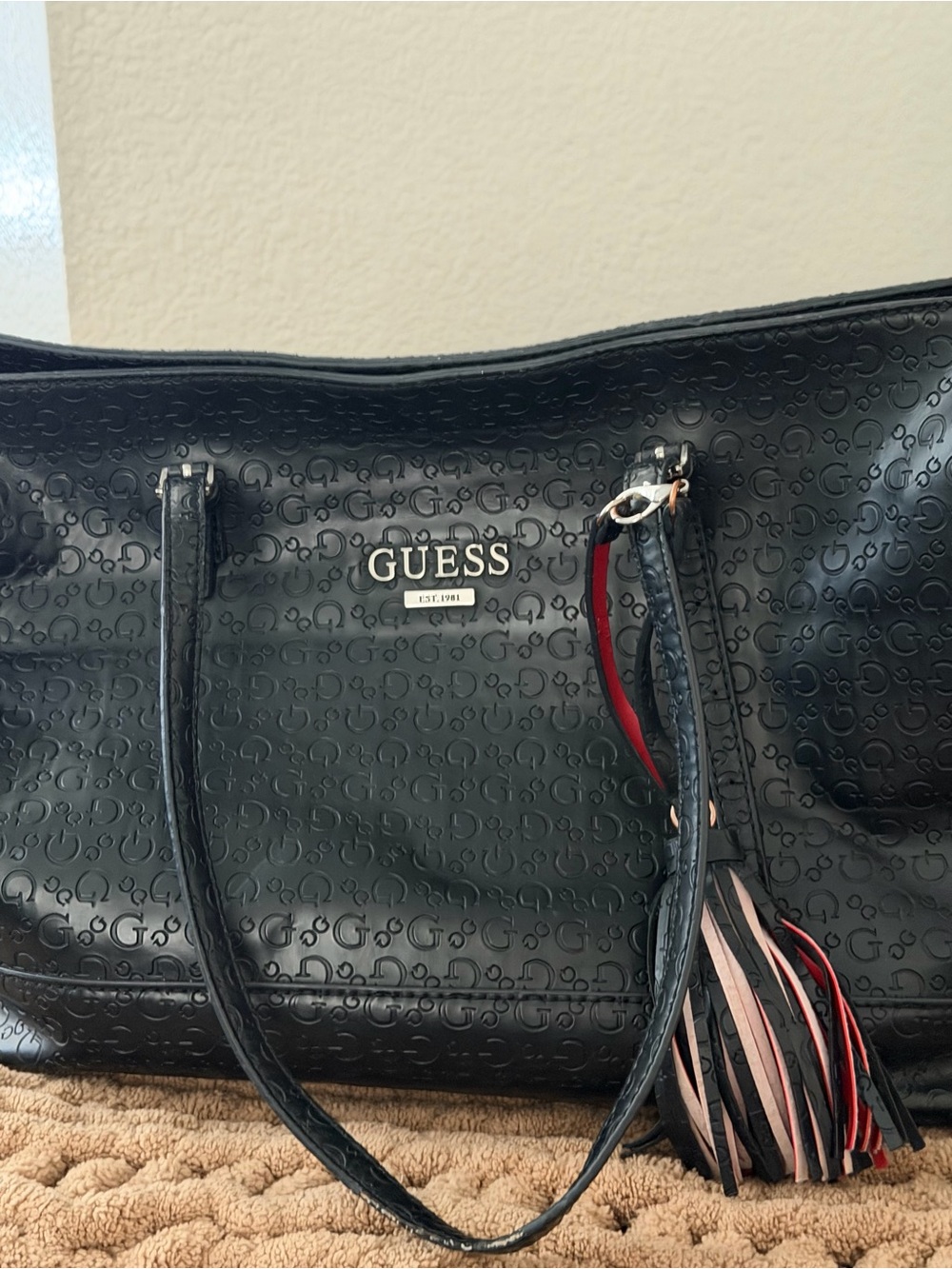 GUESS Black Embossed Logo Tote with Multicolor Tassel Accent